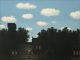Rene Magritte: “La poésie du silence” A quiet street scene at dusk evokes poésie du silence: dark silhouettes of trees and buildings frame glowing windows and a lone streetlamp, while above, a blue sky with fluffy white clouds channels the surreal calm of Rene Magritte’s art.