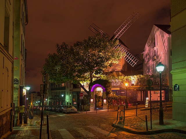 Coloured lights illuminating street and windmill in Monymatre