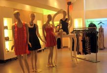 BCBG : Max Azria, la réussite sous le soleil de Californie Four mannequins display fashionable BCBG dresses in a stylish, well-lit boutique. Racks of clothing and illuminated shelves line the space, creating a modern and elegant Max Azria-inspired atmosphere that’s warm and inviting.