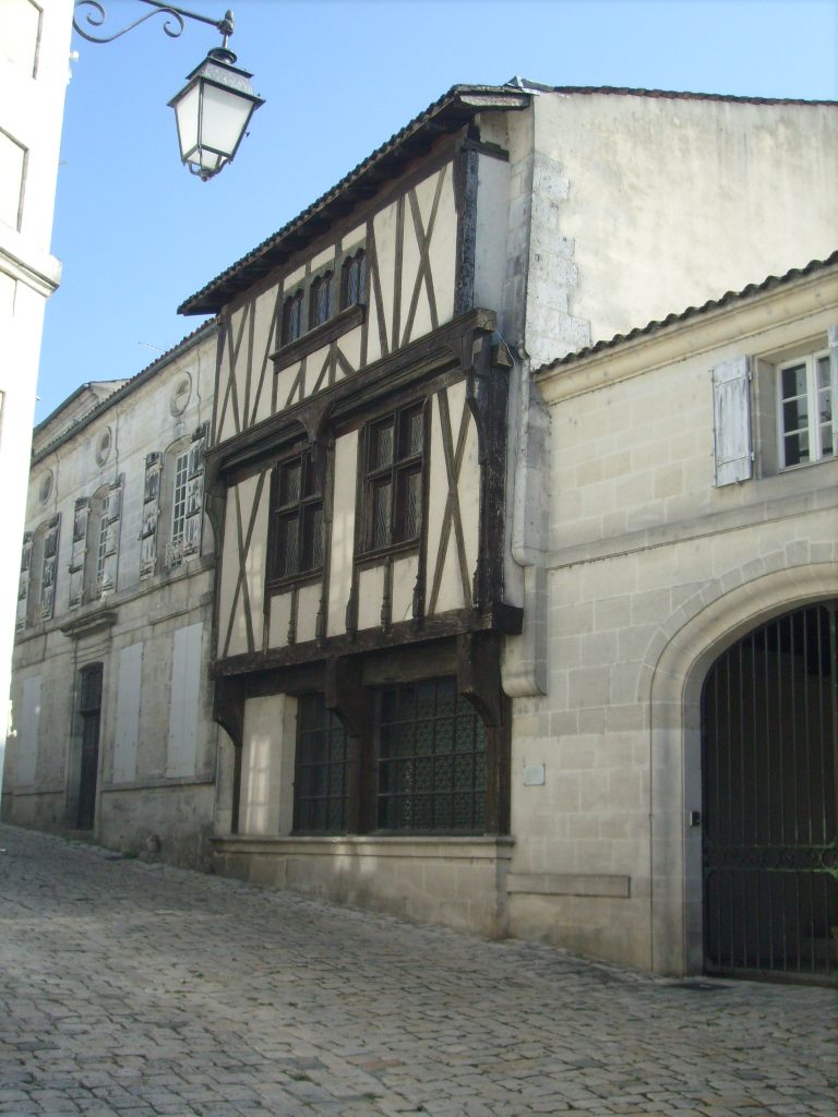 Cognac's cultural Tapestry Timbered house in cobbled streets