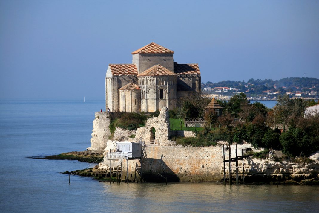 Talmont The church at Talmont on the sea wall seen from a distance jutting out into Gironde Estuary